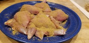 raw quail coated with poultry seasoning
